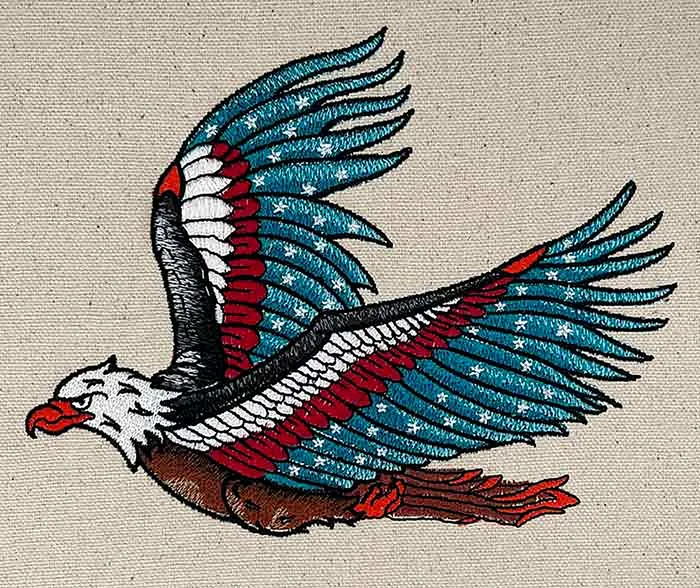 Embroidered American eagle with star-spangled wings on natural canvas